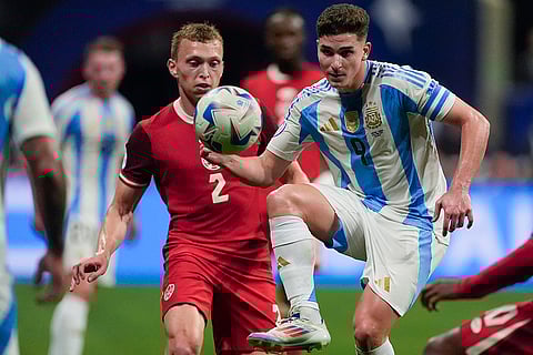 Julian Alvarez and Alistair Johnston battle for the ball